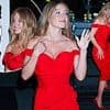 Sydney Sweeney is every inch the Hollywood bombshell in a red cocktail dress as she snaps selfies with fans at her Echo Valley premiere afterparty