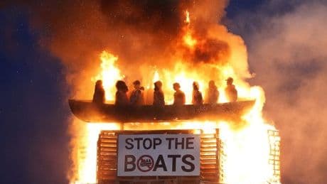 ‘Racist’ bonfire with migrant dummies on a boat set on fire