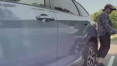 Moment woman attacks Tesla in school parking lot