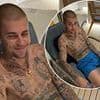 Justin Bieber appears in good spirits as he shares a rare smile while sipping on wine in shirtless snap - after new album was deemed a 'messy cry for help'
