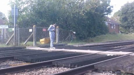 Distracted teenager stops on train tracks to check phone in shocking CCTV footage