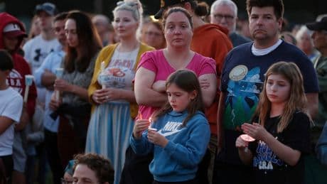 Hundreds honor 2 children killed and 17 people wounded in shooting at a Minneapolis Catholic school