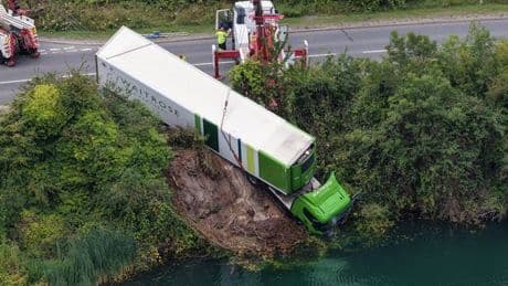 Shocking moment Waitrose lorry veers off road and plunges into lake