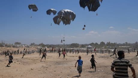 Photos show Palestinians pursuing food aid after the latest air drops in Gaza