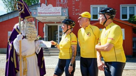 3 elves are cycling from the German town of St. Nikolaus to Finland's Santa Claus Village