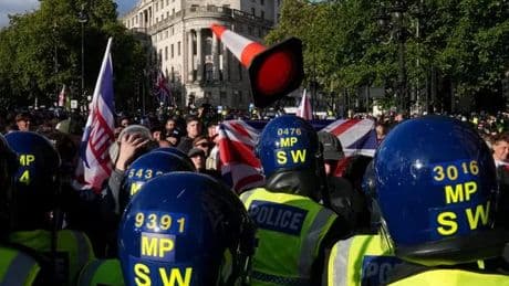Tommy Robinson protesters attack cops at at 'Unite the Kingdom' event as nine arrested