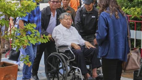 Thai construction magnate facing charge over Bangkok tower collapse surrenders to police
