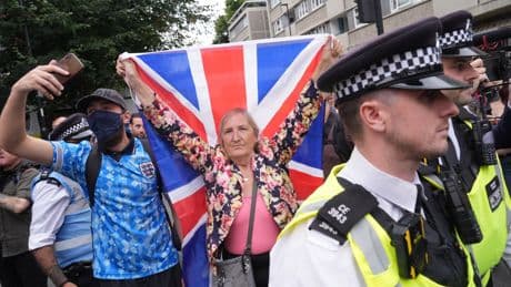 Rival groups clash outside London asylum hotel as police issue arrest warnings
