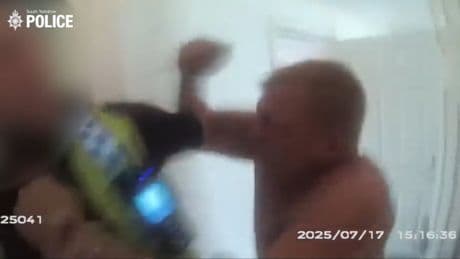 Shocking moment knifeman charges at and slashes police officer in neck