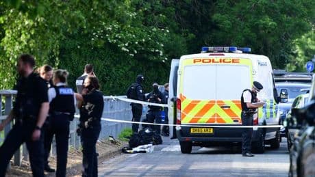Man shot by armed police after man and woman seriously injured in double stabbing
