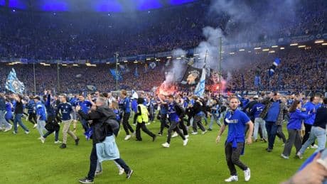 Shock moment fans storm pitch in huge invasion with 25 rushed to hospital as club wins promotion to Germany’s Bundesliga