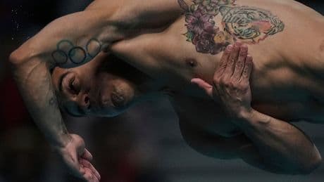 AP PHOTOS: Expressions of divers in the split second between diving board and the water