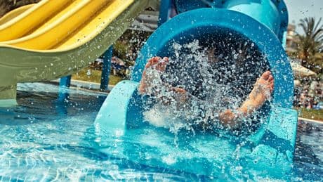 Toddler dies after ‘slipping from dad’s arms while going down slide’ at waterpark