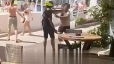 Shocking moment Marbella cop SLAPS sunbather as two people are arrested during major crackdown on beach vendors
