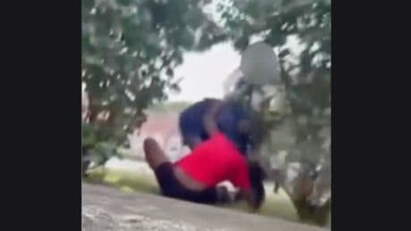 Post office worker seen on camera beating young girl while in full uniform