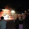 Chaos outside Epping's migrant hotel as protest videos emerge of lit flares 'being thrown' from windows whilst 'terrified' residents claim 'fireworks were aimed at building' as police confirm arrest