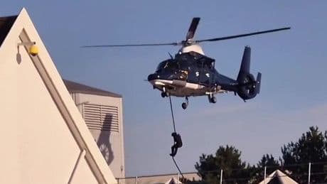 Shoppers in shock as masked figures drop from helicopters and storm building near Tesco