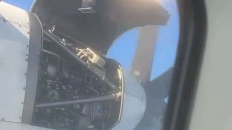 Horrifying moment plane engine panel comes off mid-air and begins to flap dangerously just inches from the propeller