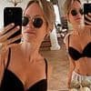 Chloe Madeley showcases her washboard abs in a black bikini as she enjoys a family holiday in France