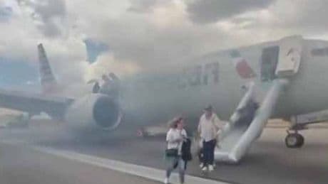 American Airlines jet with 182 people on board goes up in flames forcing evacuation