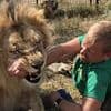 Horrifying moment 'lion whisperer' is mauled by big cat and 'dragged by his neck like a toy' - leaving him fighting for life