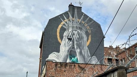 A new mural in France shows the Statue of Liberty covering her eyes in a swipe at Trump