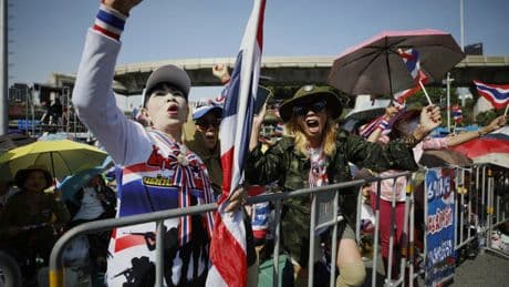 Protesters in Bangkok demand resignation of court-suspended prime minister following deadly conflict