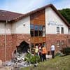 Eight people are rushed to hospital after BMW ploughs into care home - as man, 21, is arrested