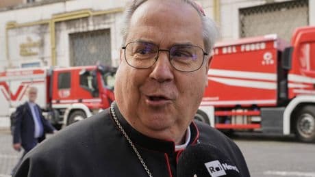 Journalists swarm cardinals at the Vatican gates as they meet to plan a conclave
