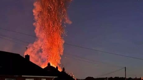Huge blaze rises over residential street with plumes of smoke seen for miles as firefighters battle fire