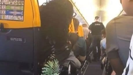 Cops board Ryanair flight after passenger 'tries to open emergency exit' mid-air