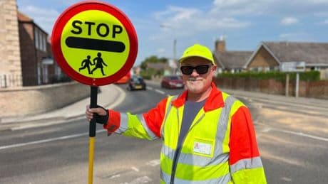 Lollipop man told to stop high-fiving kids because it delayed cars by 10 seconds