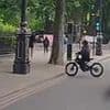 Shocking moment e-bike phone thief dangerously veers across traffic to grab mobile from stunned pedestrian victim