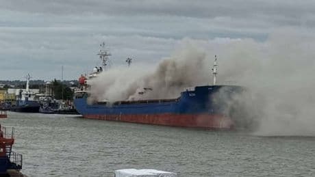 Huge fire on cargo ship sends smoke and ‘burning plastic’ smell billowing into city centre