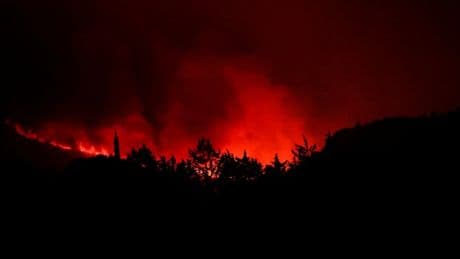 One person dies and hundreds flee after wildfires spread across France and Spain