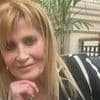 Woman, 66, arrested over murder of film director, 69, found dead in her flat with diamond Rolex missing