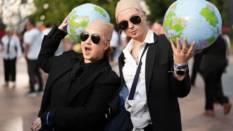 White shirts. Black ties. Bald caps. Pitbull’s fans party like clones worldwide