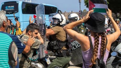 Riot police scuffle with demonstrators on Greek island during visit by Israeli cruise ship
