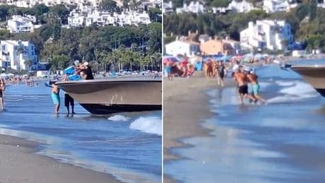 Incredible moment 'drug smugglers' causally unload shipment in front of shocked tourists on Spanish beach