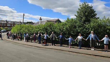 Glasgow residents form 'massive hug' around green space threatened by developers