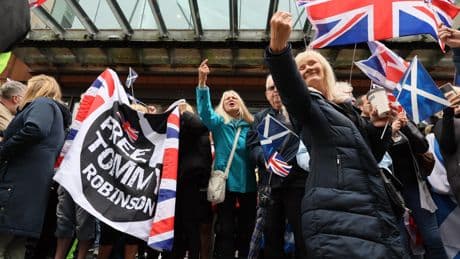 Pictured: 'National strike' and anti-racism protestors separated by police in Glasgow