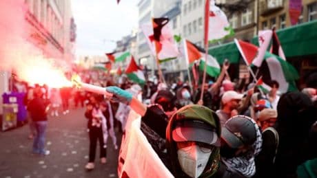Pro-Palestine protesters gather in Basel with flares and smeared blood ahead of Eurovision final