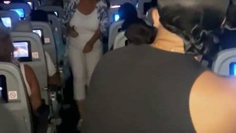 Passengers pin down man who tries to open plane door mid-flight
