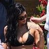 Kylie Jenner sizzles in a busty black string bikini top as she joins ab-baring sister Kendall for pool party in Venice as Jeff Bezos and Lauren Sanchez's $20M wedding festivities continue
