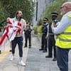 Flag wars boil over as activist confronts workers tearing down St George's Cross on orders of council that prided itself on Palestinian banners