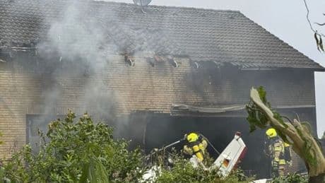 Plane crash kills two people after bursting into flames in front garden