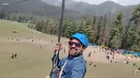 Staggering moment tourist ziplines over valley unaware of deadly TERROR ATTACK unfolding below as gunshots ring out