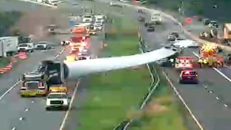 Huge wind turbine blade falls off truck and crashes into traffic on busy interstate