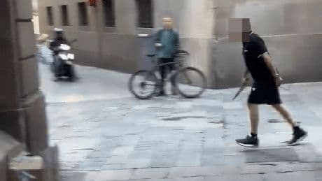 Chilling moment man runs through Barcelona with huge knife as tourists flee down narrow street