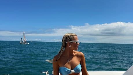 Megan Moroney makes waves in blue bikini and cross necklace during summer boat day